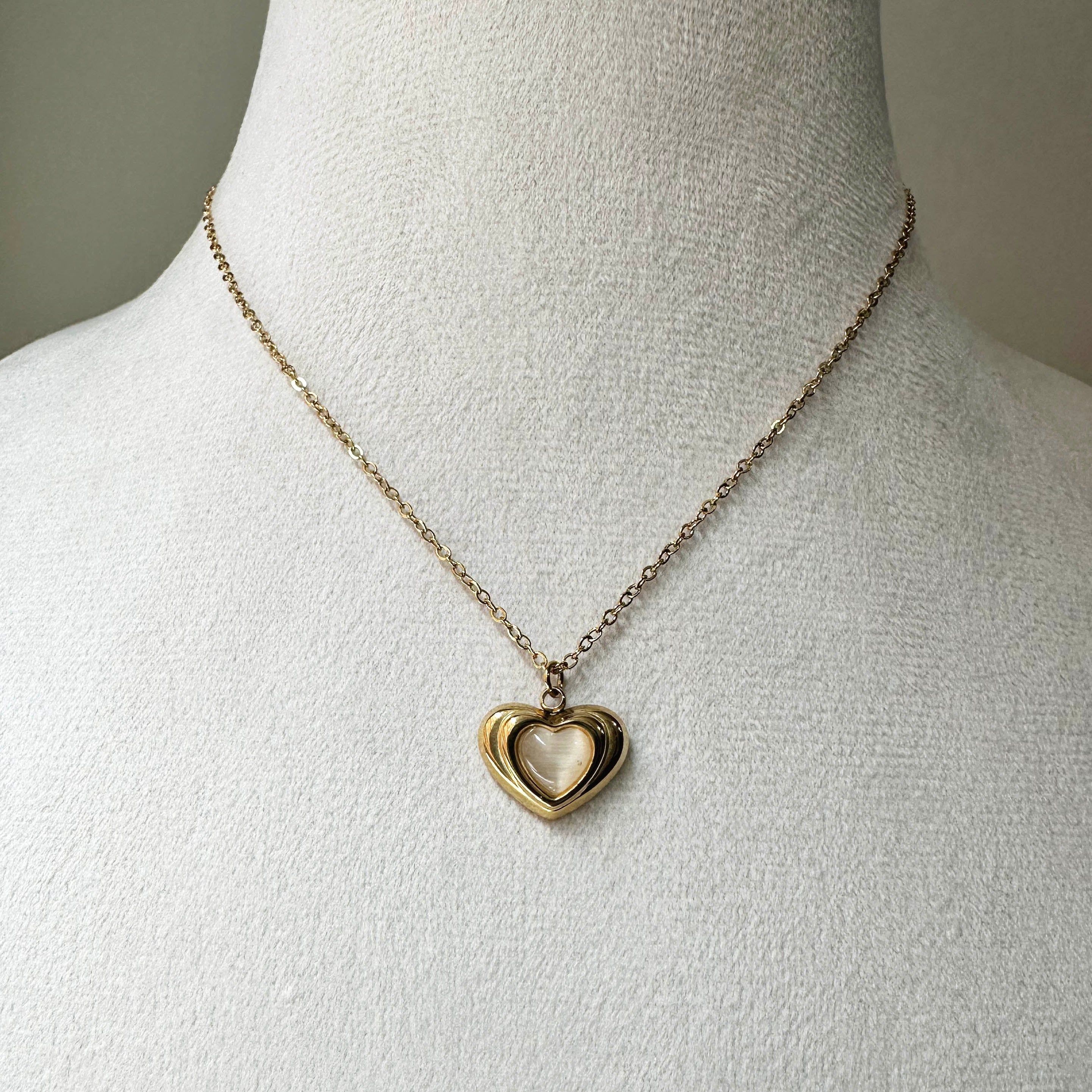 Close-up view of the sculptural, multi-layered heart frame on Dimensional Heart Pendant