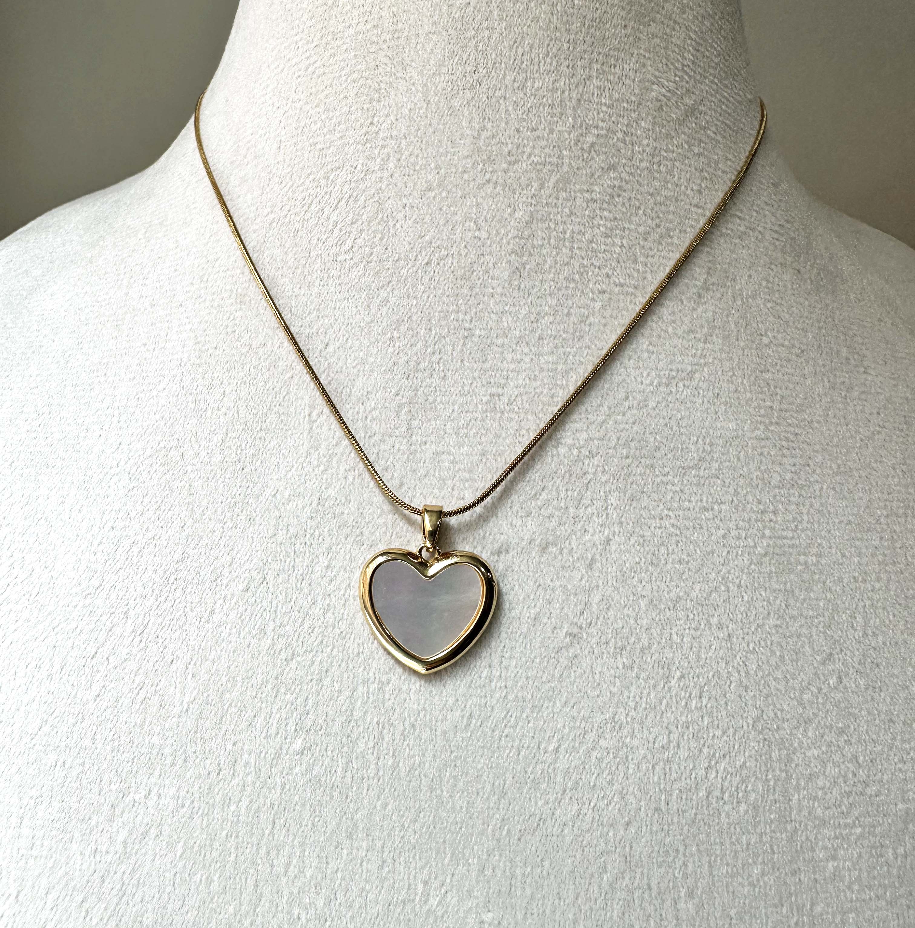 view of Minimalist Heart Pendant highlighting the refined metal profile and the depth of the MOP inlay