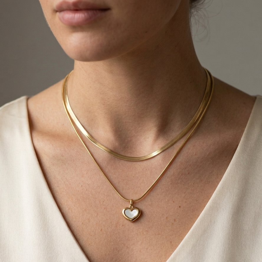 Model wearing Dual Heart MOP Necklace to showcase its layered silhouette and elegant drape against the neckline