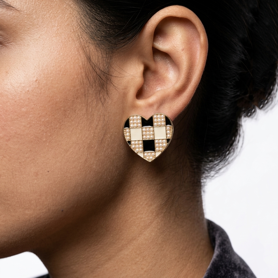 Model wearing The Checkered Heart studs to highlight their structural scale and classic appeal against the ear