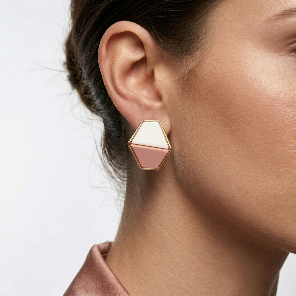 Model wearing The Facet studs to showcase their unique, sculptural scale and high-luster, anti-tarnish aesthetic against the ear