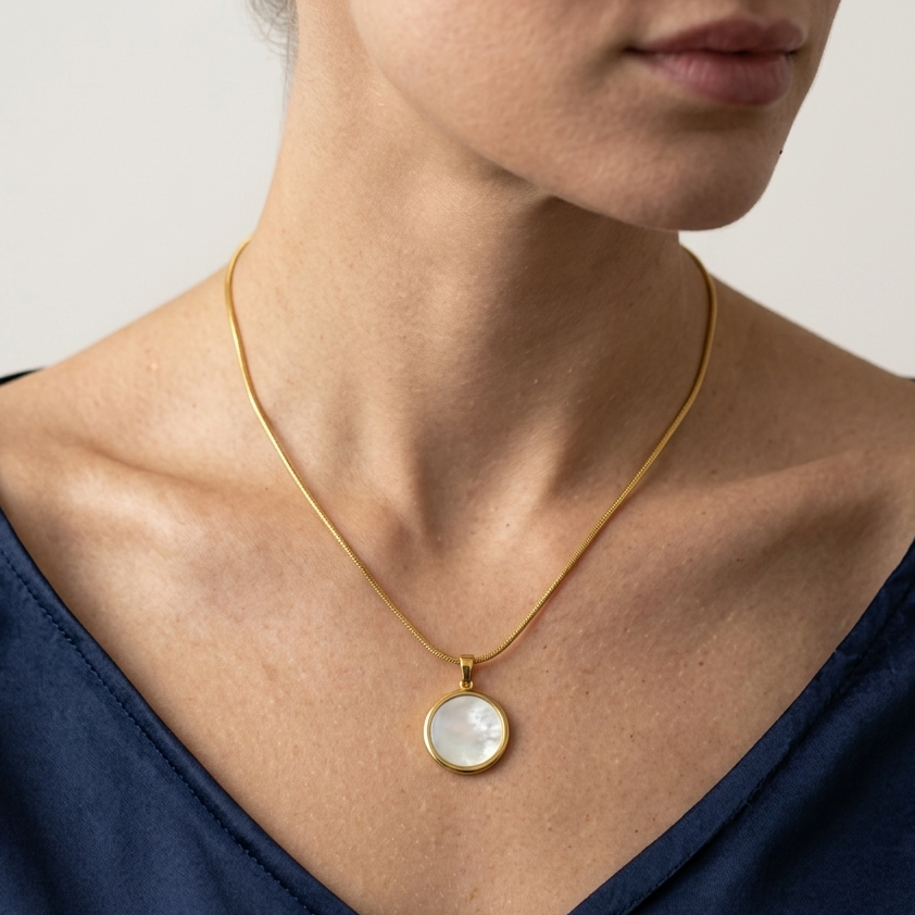 Model wearing round disc pendant necklace