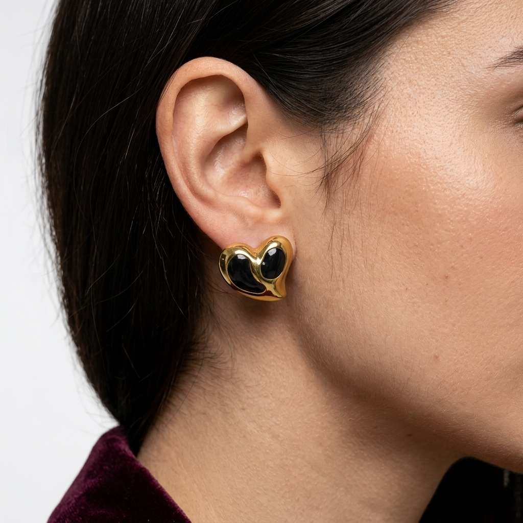 Model wearing The Soul Heart studs to showcase their sculptural scale and polished, anti-tarnish aesthetic against the ear