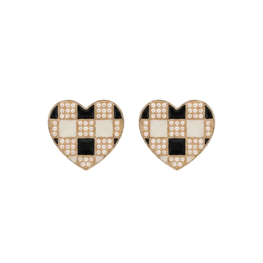 The Checkered Heart Studs, a pair of handcrafted brass earrings featuring a heart silhouette with a monochrome chessboard pattern of pearls and enamel