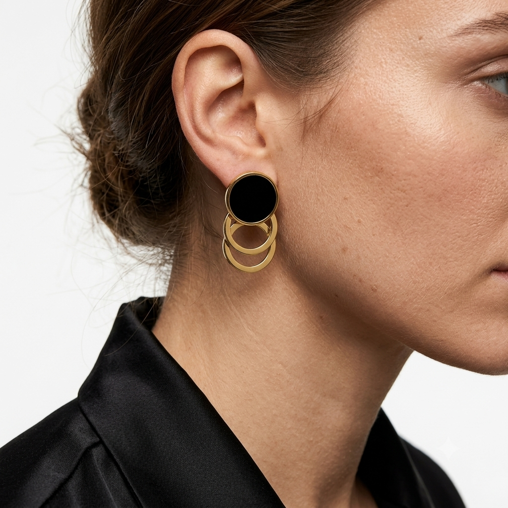 Model wearing the black and gold Onyx Cascade hoop earrings to show scale and movement