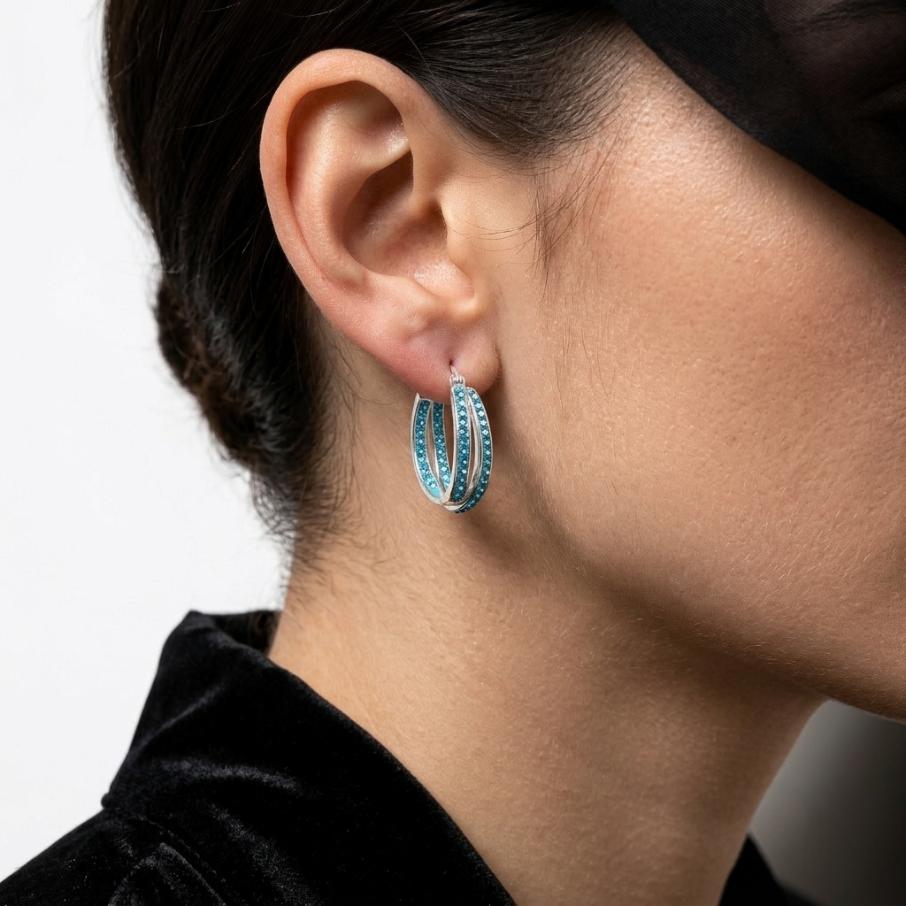 Model wearing the silver and blue Cyan Glace split-band hoop earrings to showcase scale and sparkle