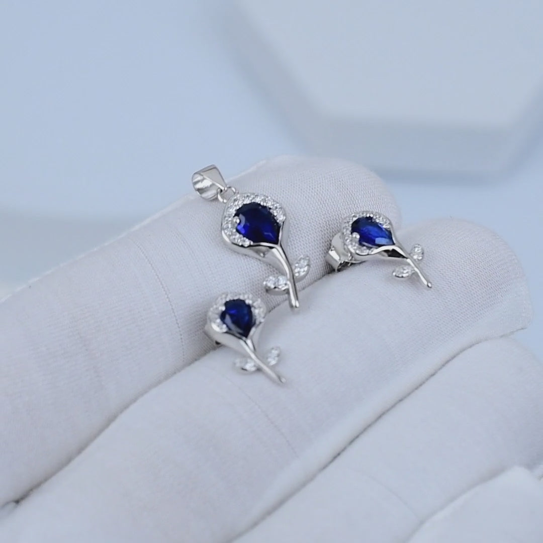 Video showcasing Sapphire Bloom Pendant Set in 925 sterling silver with blue stone detailing and matching earrings