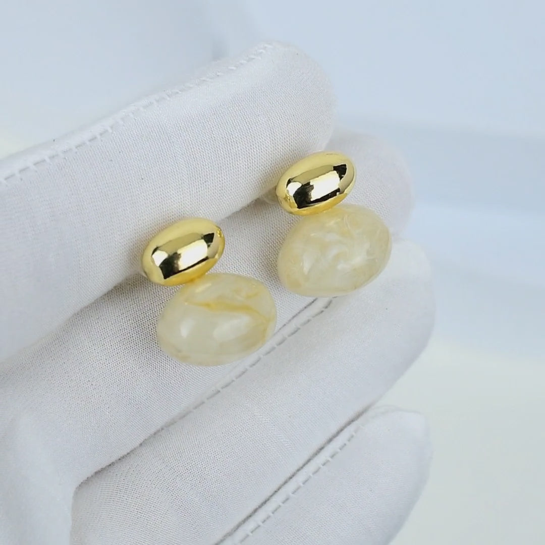Luxury resin and metal stud earrings displayed on white background by Civaro