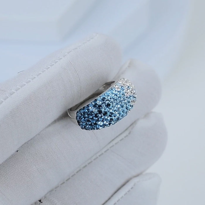 Video showing the fluid light reflection and the seamless color transition across the crystals of the handcrafted Signature Ombré Dome ring