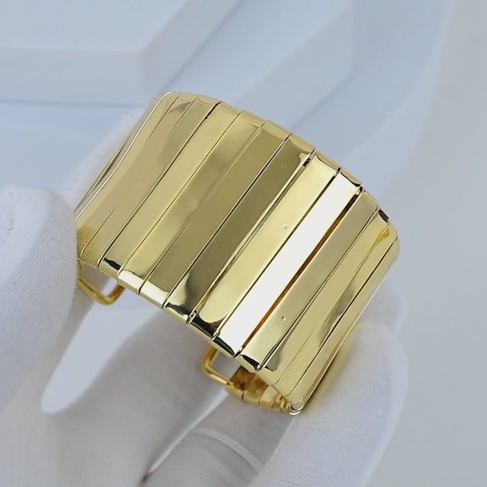 Video showing the flexible movement and high shine liquid reflection of the gold toned Aurelia segmented cuff bracelet