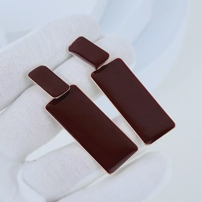 Video showing the movement, full gold-toned back, and reflective brown enamel of the Sienna earrings
