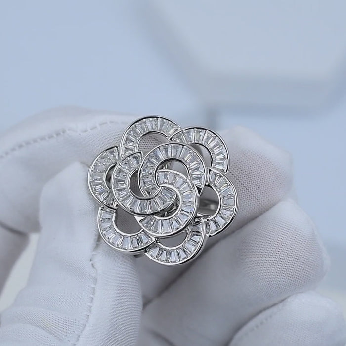 Rhodium plated silver flower ring with brilliant stone detailing showing in hand