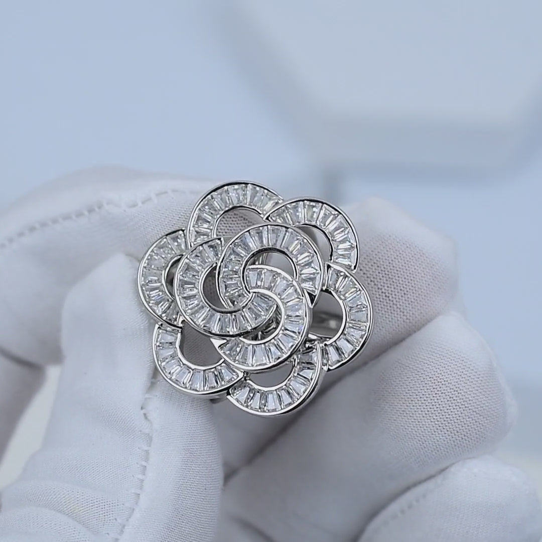 Rhodium plated silver flower ring with brilliant stone detailing showing in hand