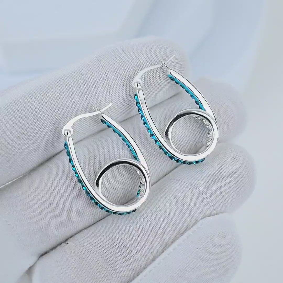 Video showcasing blue crystal double hoop earrings with sparkling crystal details