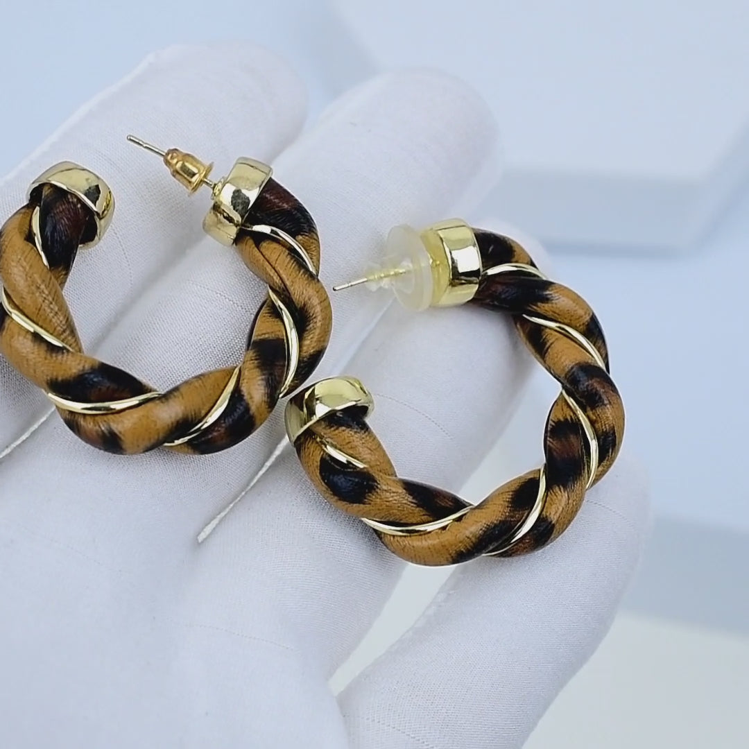     Savanna Twirl Hoops rotating to show sculpted texture and light reflection
