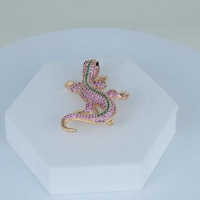     Designer-inspired crystal lizard pin displayed on a white pedestal background.