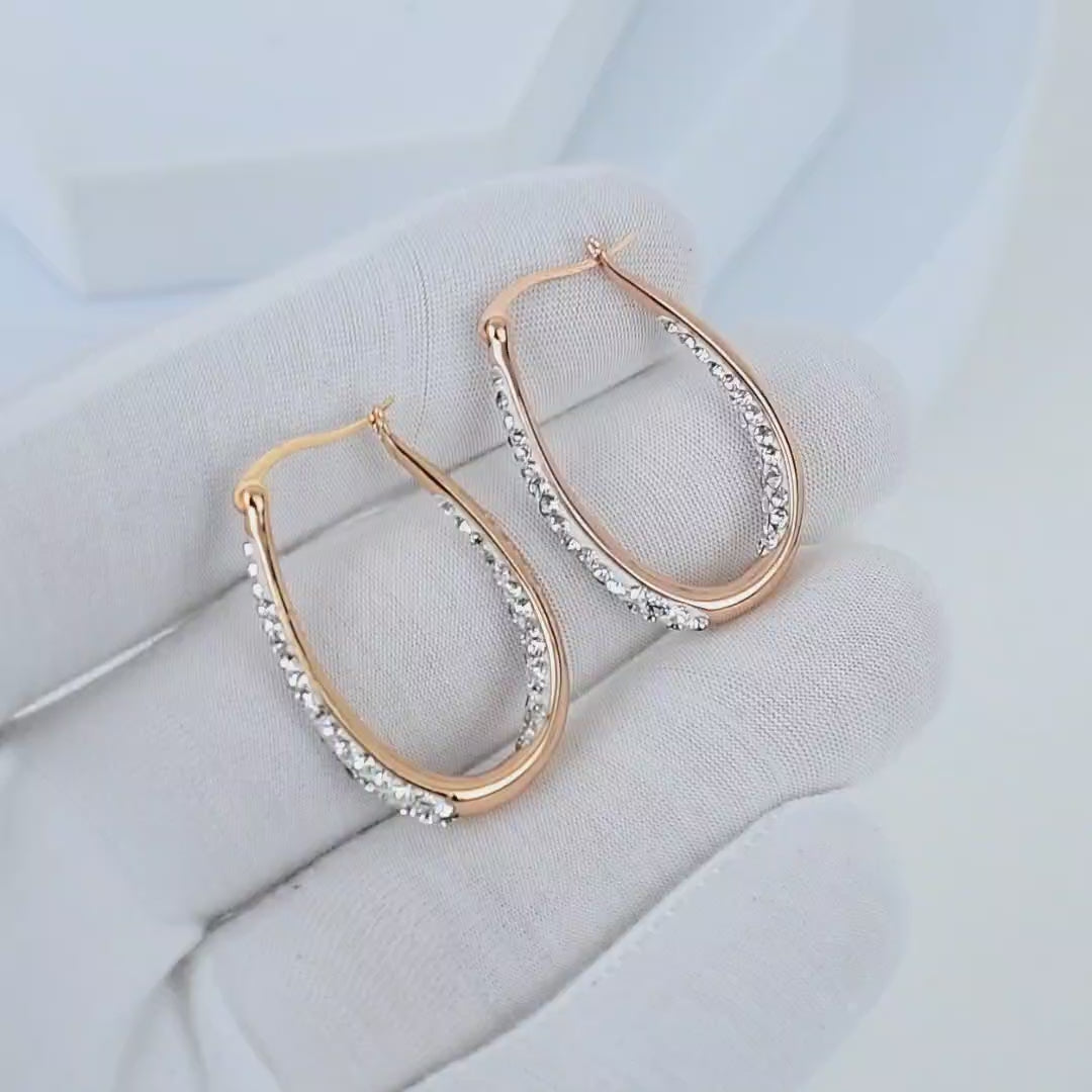 Video showcasing rose gold crystal hoop earrings with sparkling crystal detailing