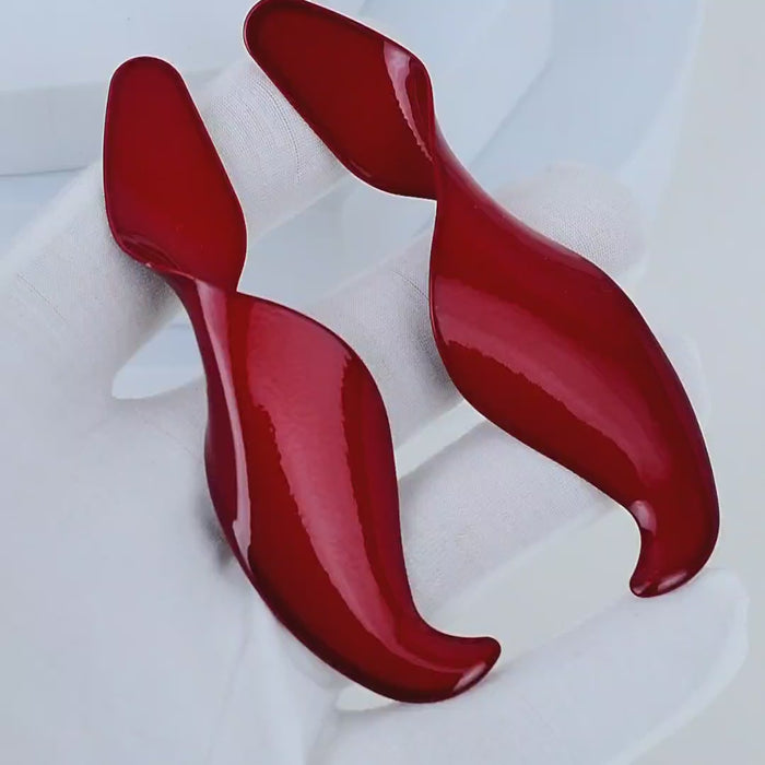 Video showing the liquid light reflections on the glossy red Crimson Fluidity earrings