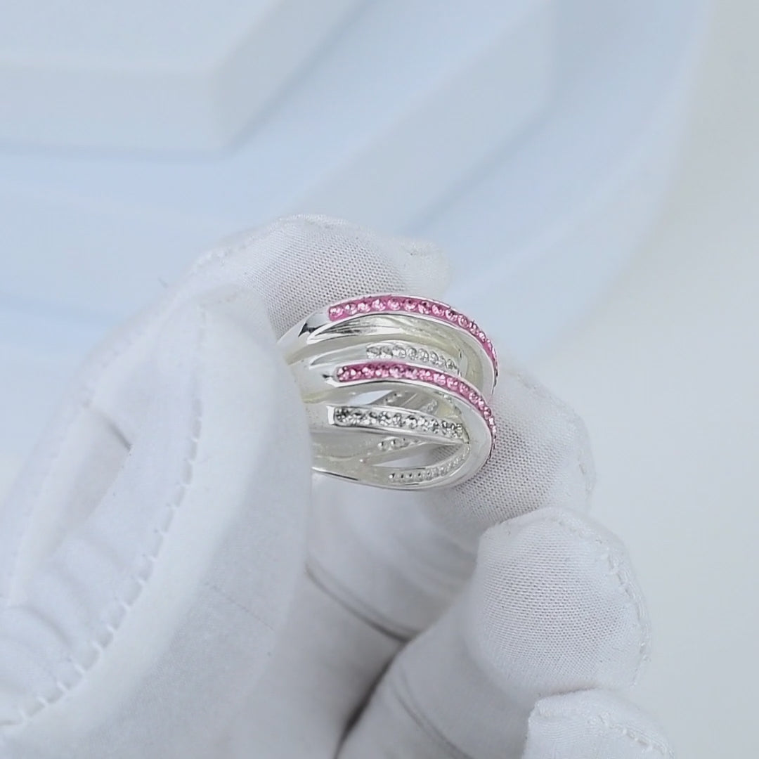Video showcasing the intricate handcrafted details, fluid movement of the crisscross design, and high-shine brilliance of the Signature Pink Crossover ring