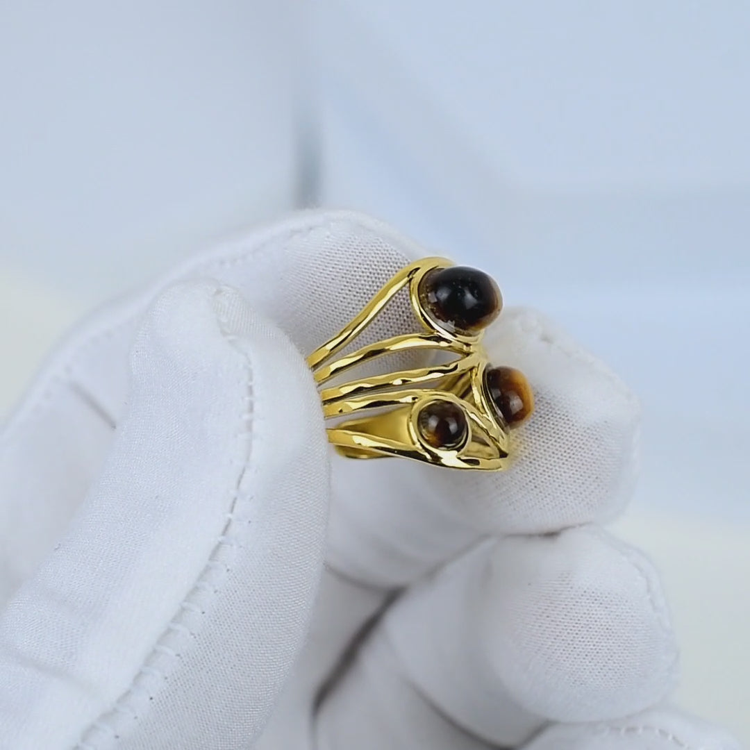 Elegant handcrafted tiger eye ring with openwork gold design.