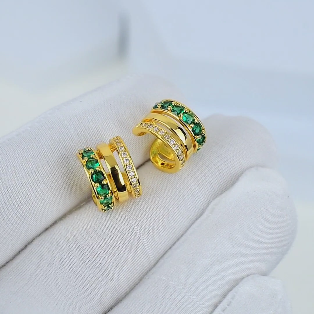 Elegant handcrafted ear cuff with green crystals and polished gold finish by Civaro.