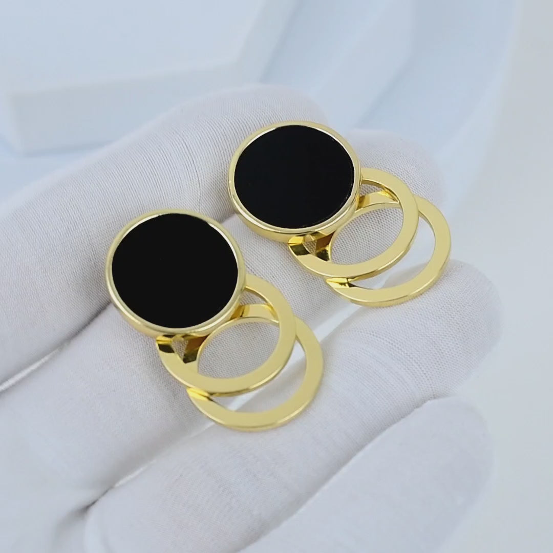 Video showing the fluid kinetic motion and light reflections on the gold hoops of the Onyx Cascade earrings