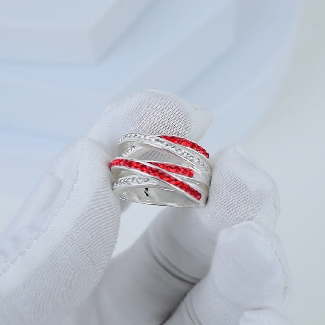 Video showcasing the intricate handcrafted details, fluid movement of the crisscross design, and high-shine brilliance of the Signature Crimson Crossover ring