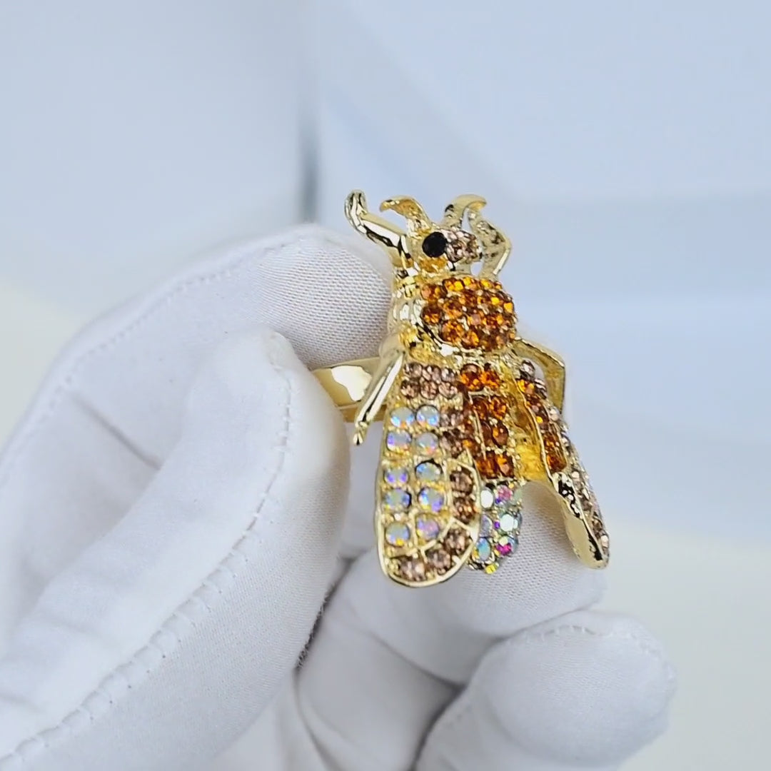 Contemporary bee statement ring with shimmering crystal embellishments.