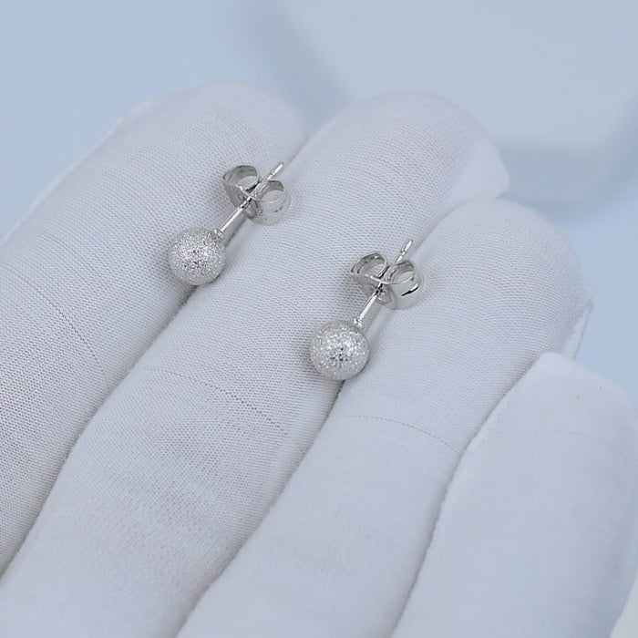 Side view of stainless steel disco ball stud earrings