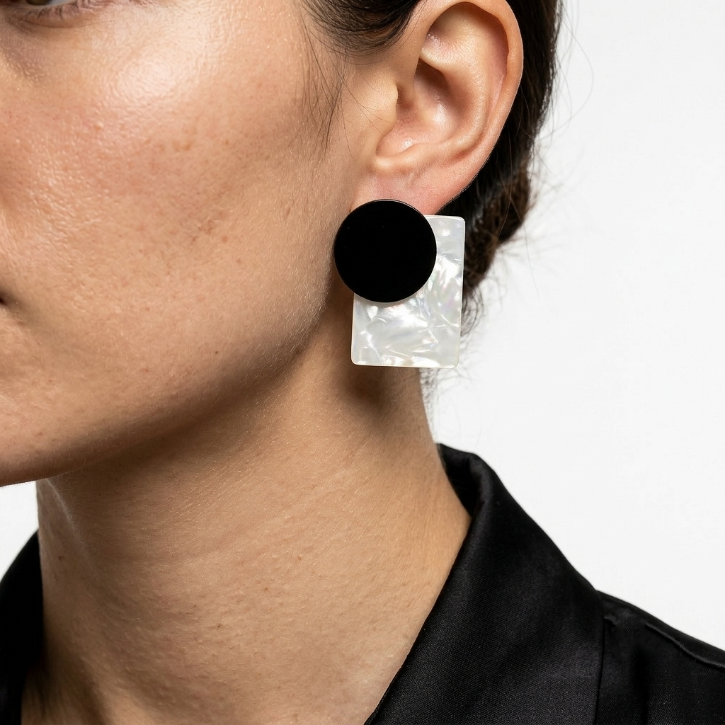 Model wearing the monochrome Onyx Aura acrylic resin geometric statement studs to demonstrate scale